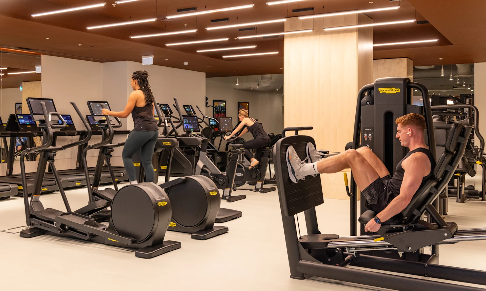 A resident using a leg press machine in the gym