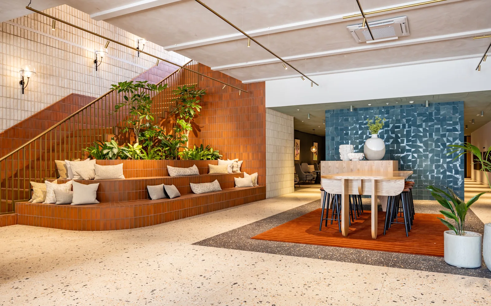 A resident lounge with a staircase and a dining table