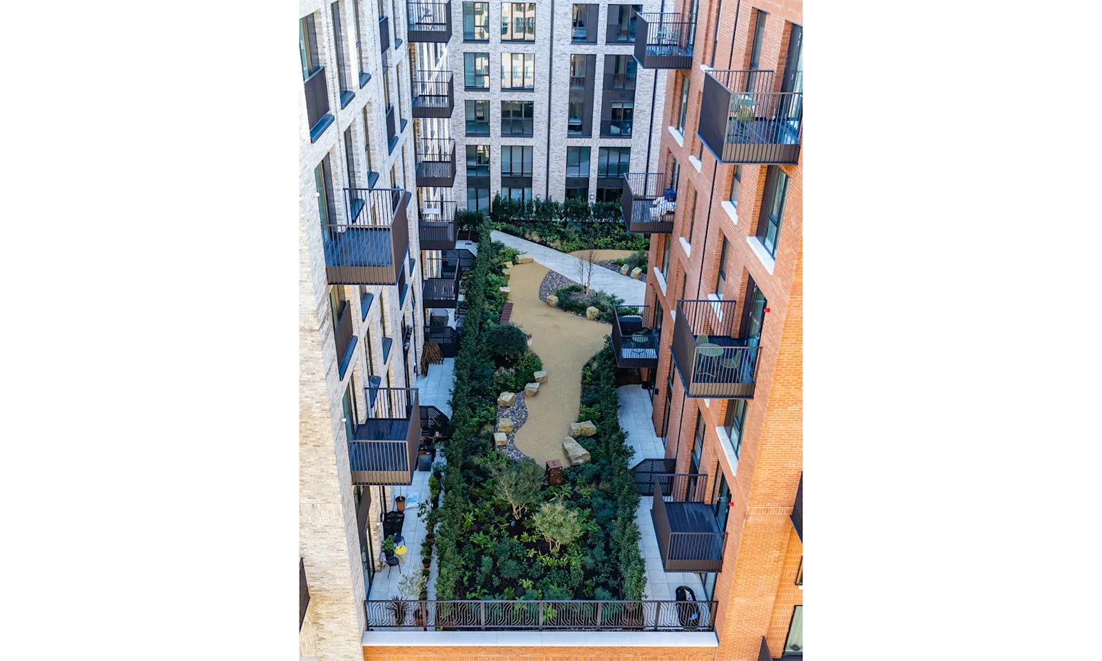 A courtyard surrounded by brick buildings with balconies