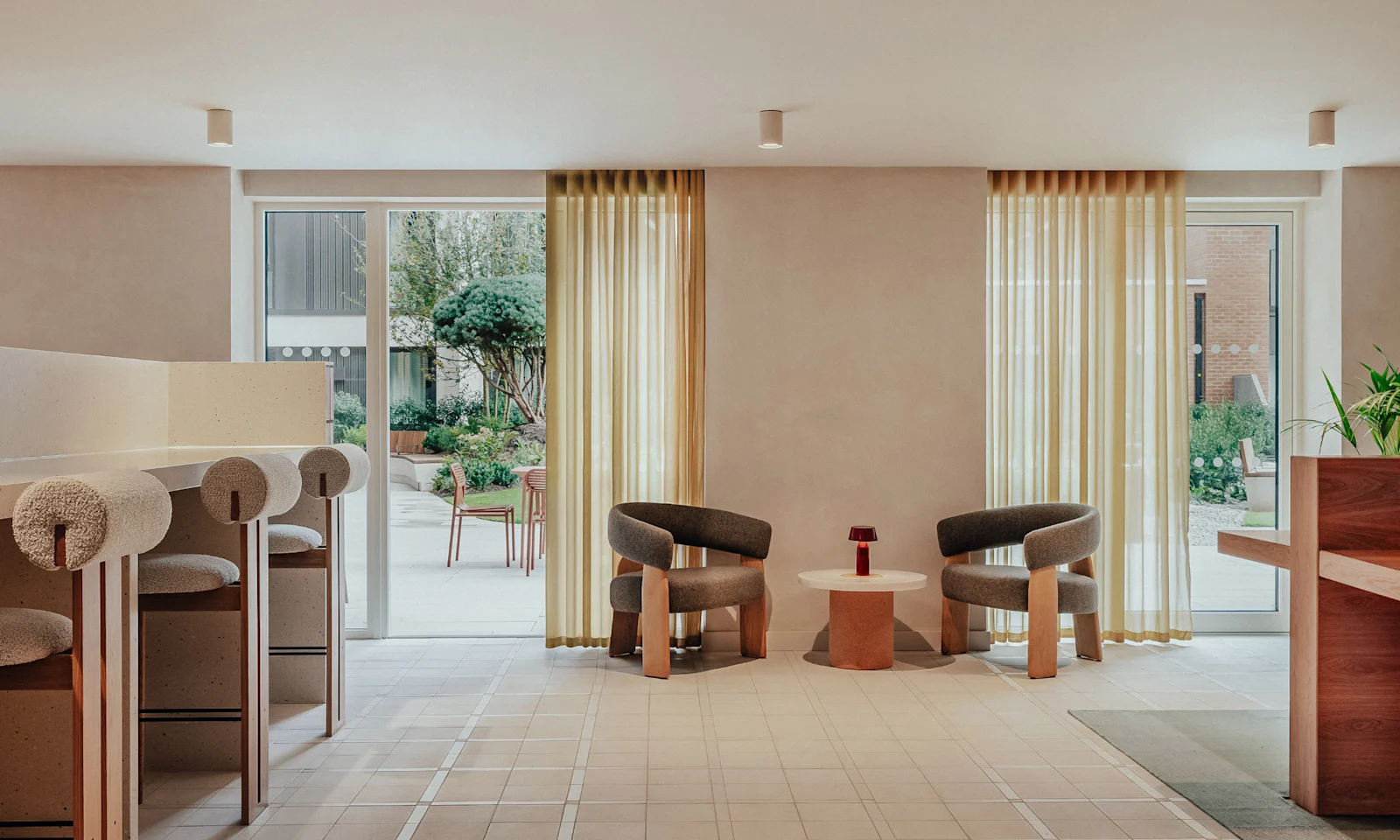 A co-working room with a table, chairs and a plant