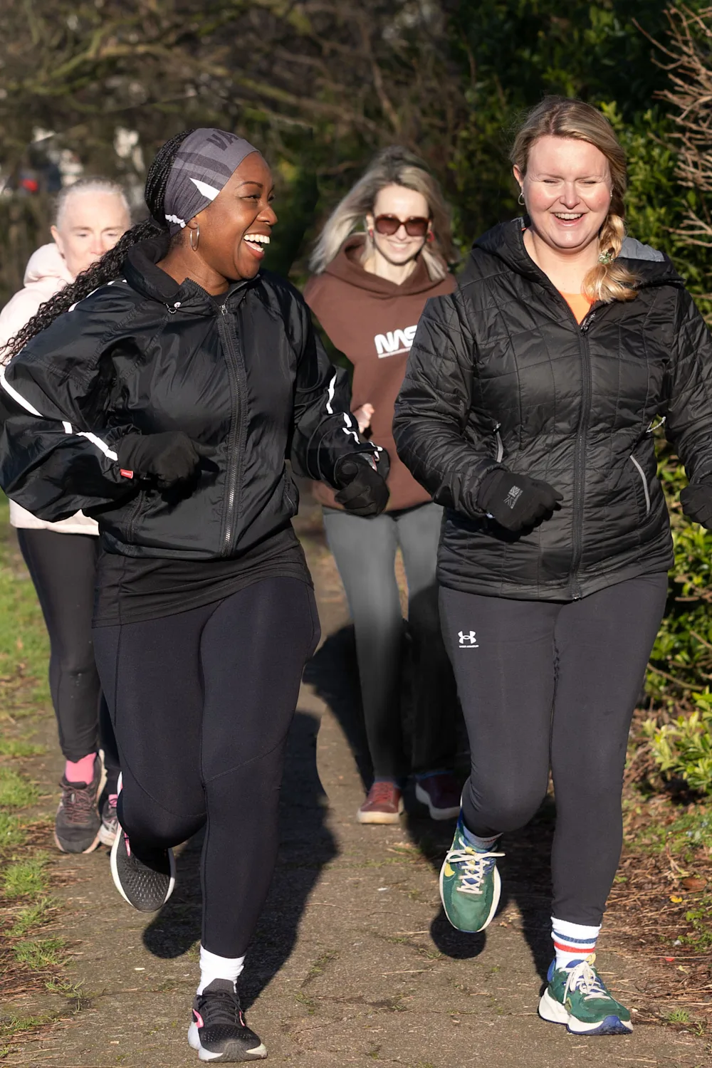 Residents on a group run through the park
