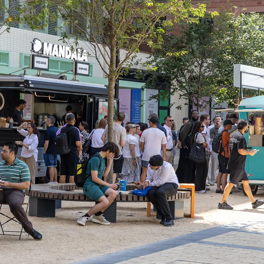 People gathered around street food stalls in Brent Cross Town